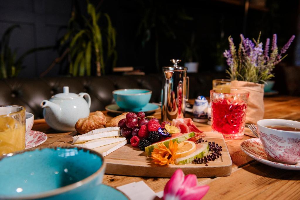 a wooden table with a plate of fruit and drinks at The Joiners Arms in Chathill