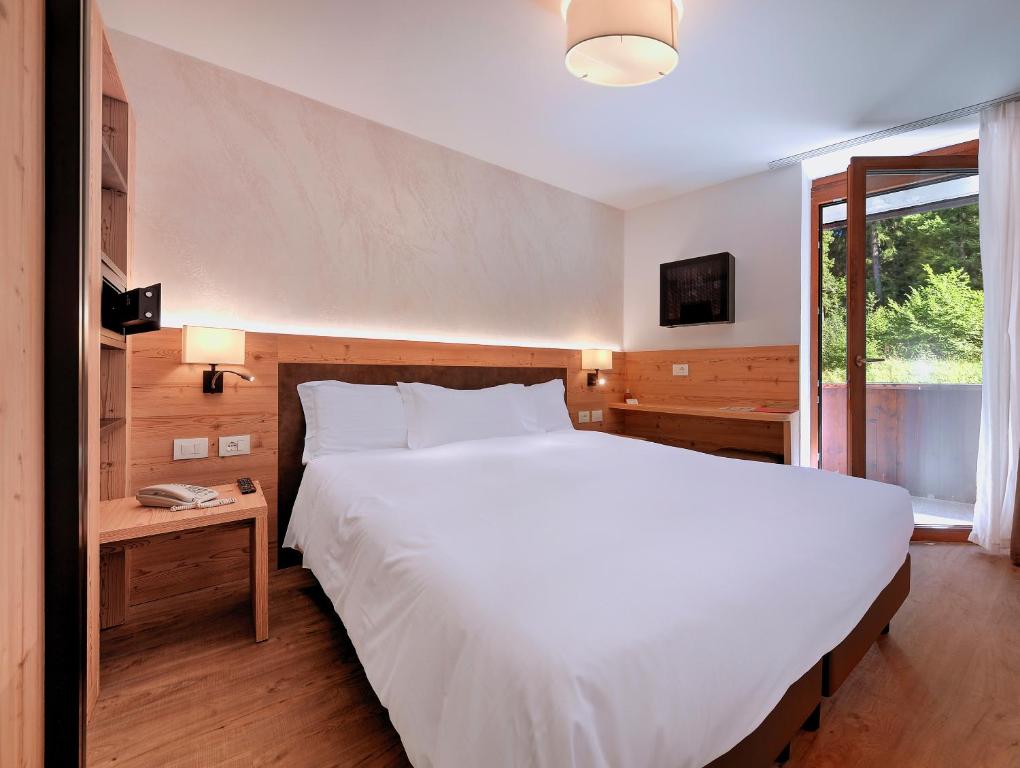 Postel nebo postele na pokoji v ubytování Luna Wellness Hotel