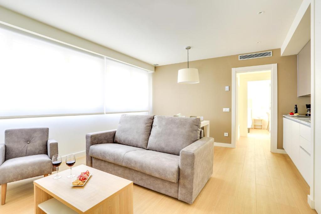 a living room with a couch and a table at Sercotel Logroño Suites in Logroño