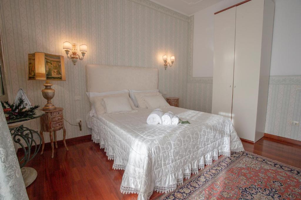 a bedroom with a bed with two towels on it at A due passi olbia in Olbia