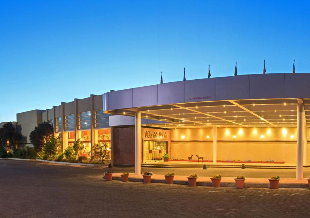 a large building with lights on it at night at Hotel Marina Villa del Rio in Valdivia