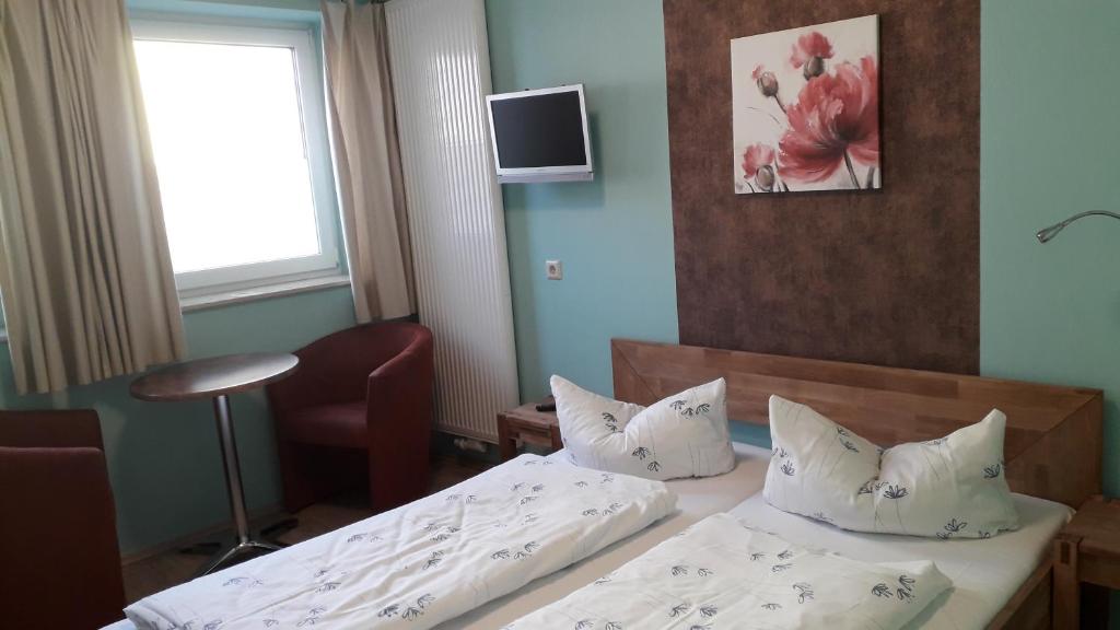 Postel nebo postele na pokoji v ubytování Hotel Wittenberg-Hotel Garni