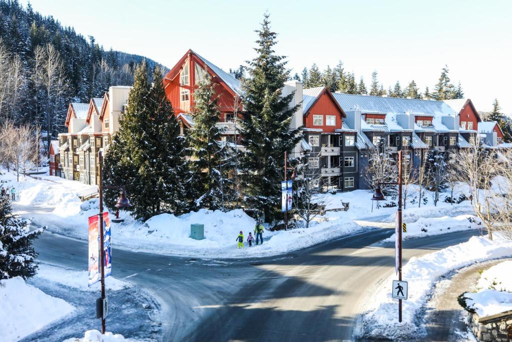 a resort in the mountains with snow on the ground at Lake Placid Lodge by Whiski Jack in Whistler