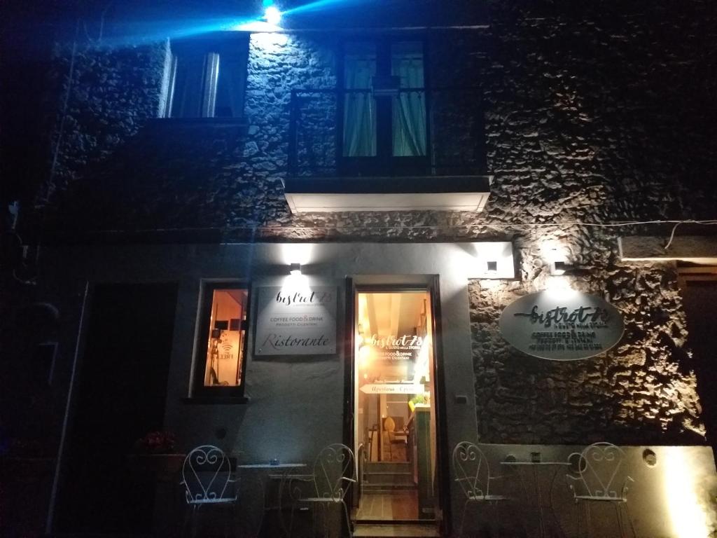 a building with a sign on the side of it at night at Room73 in Paestum