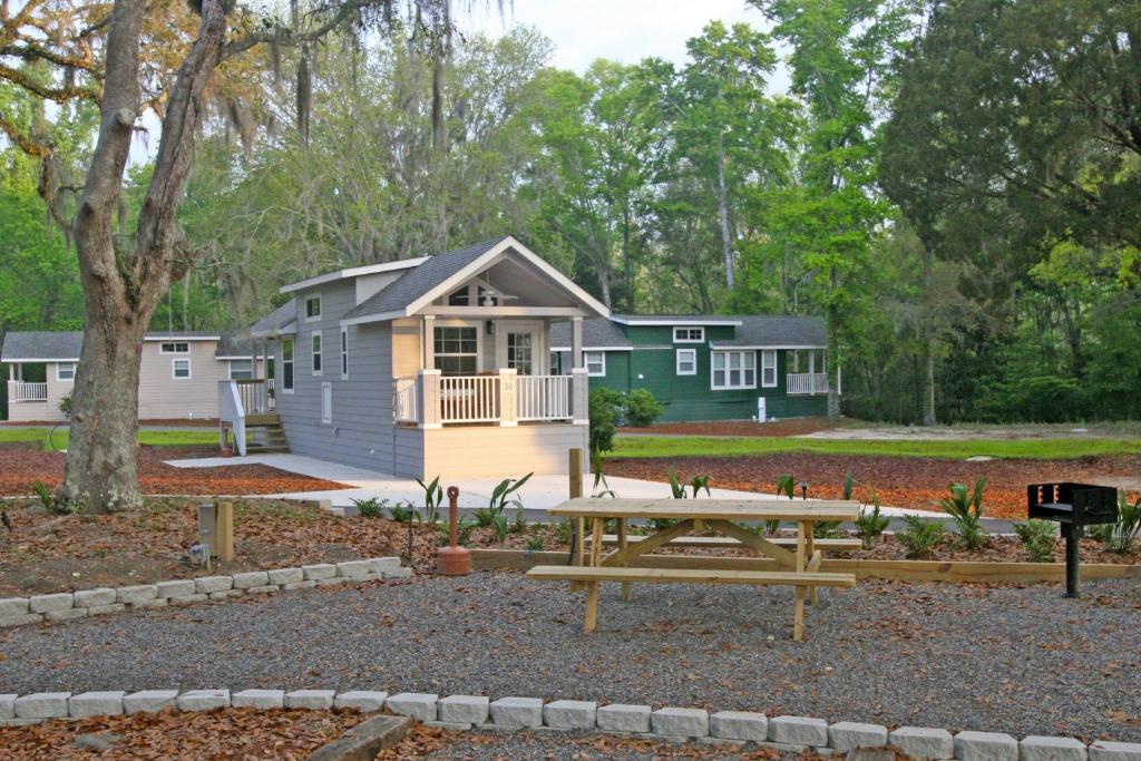 a tiny house with a picnic table in front of it at Live Oak Landing in Freeport