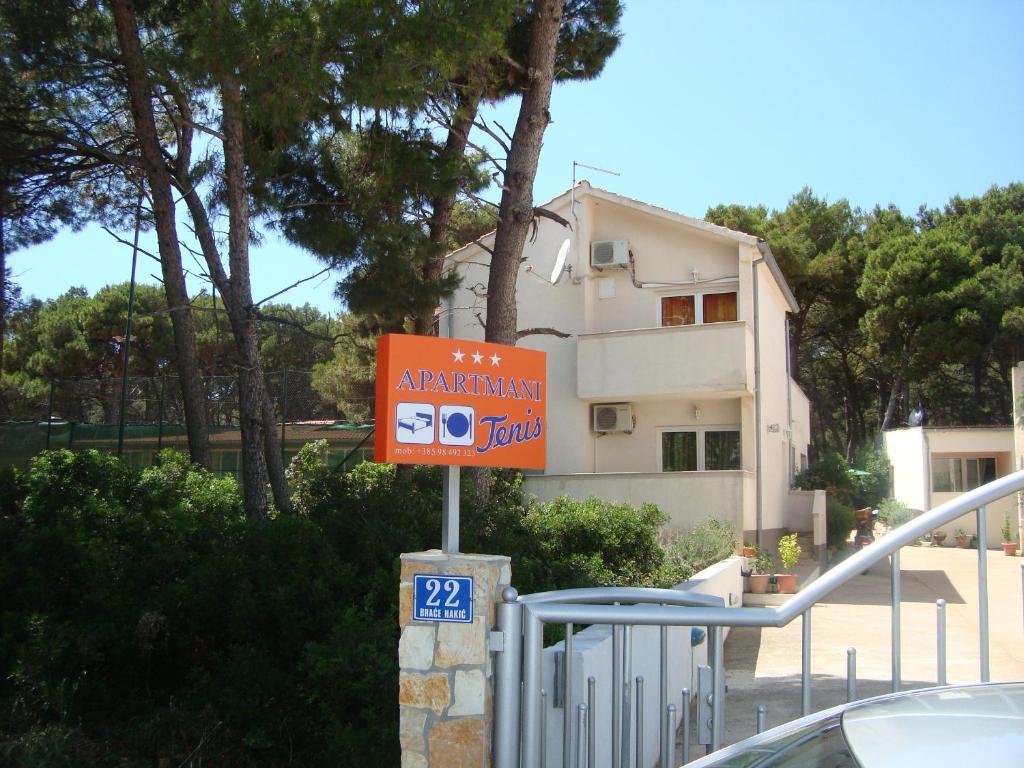 a orange sign in front of a building at Apartments Jurić - Zablaće in Zablaće