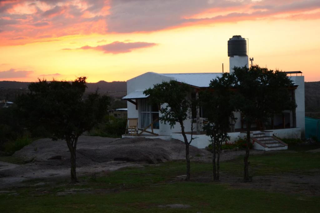 a house with a lighthouse on top of a hill at Cabañas Los Relinchos in Capilla del Monte