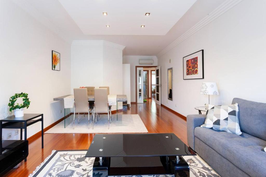 a living room with a couch and a table at luxury lisbon apartment T2 in Lisbon