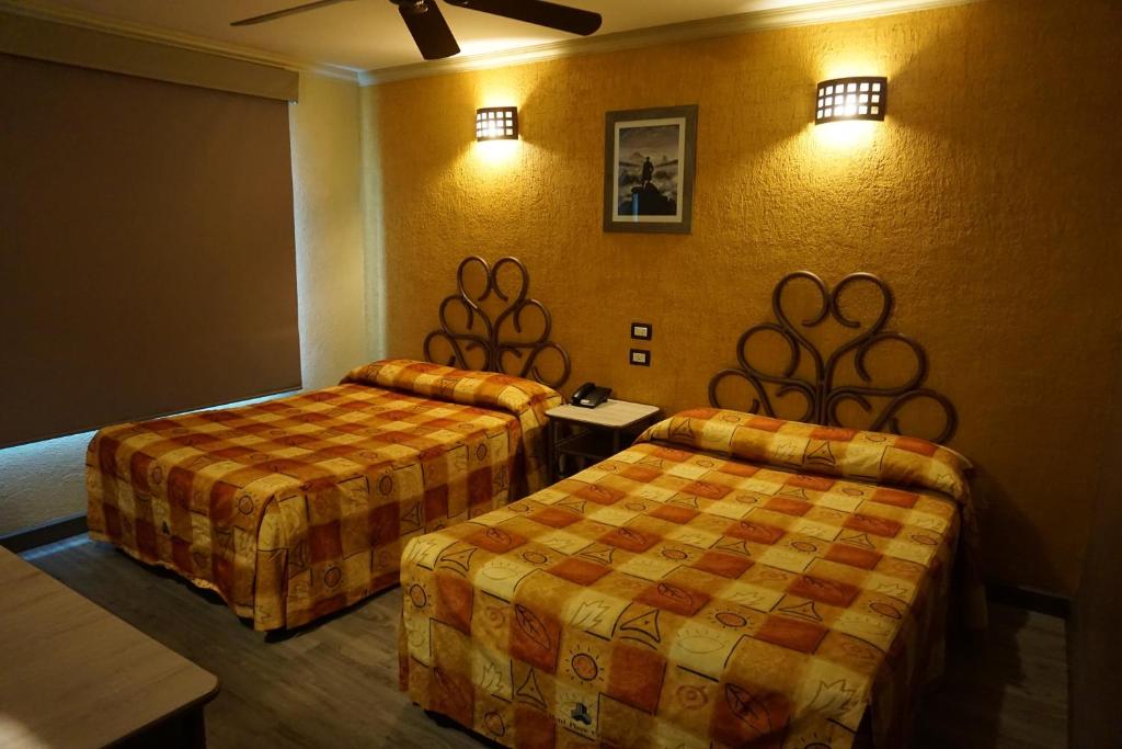 Postel nebo postele na pokoji v ubytování Hotel Plaza Crystal
