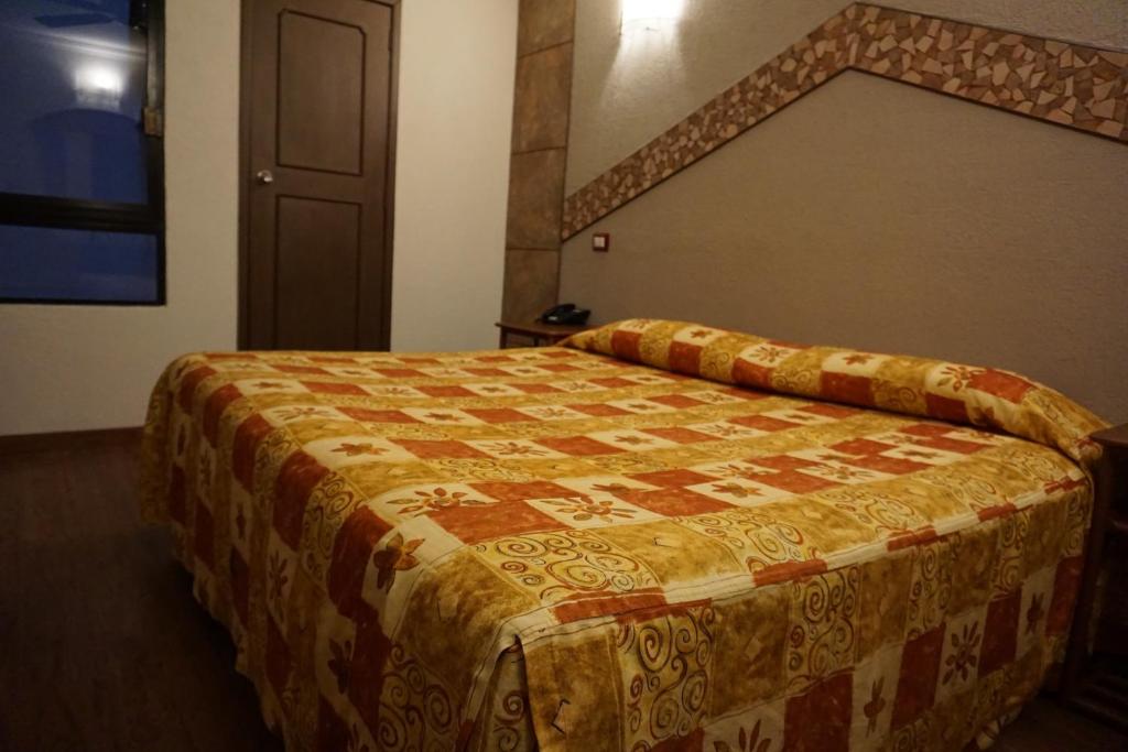 Postel nebo postele na pokoji v ubytování Hotel Plaza Crystal