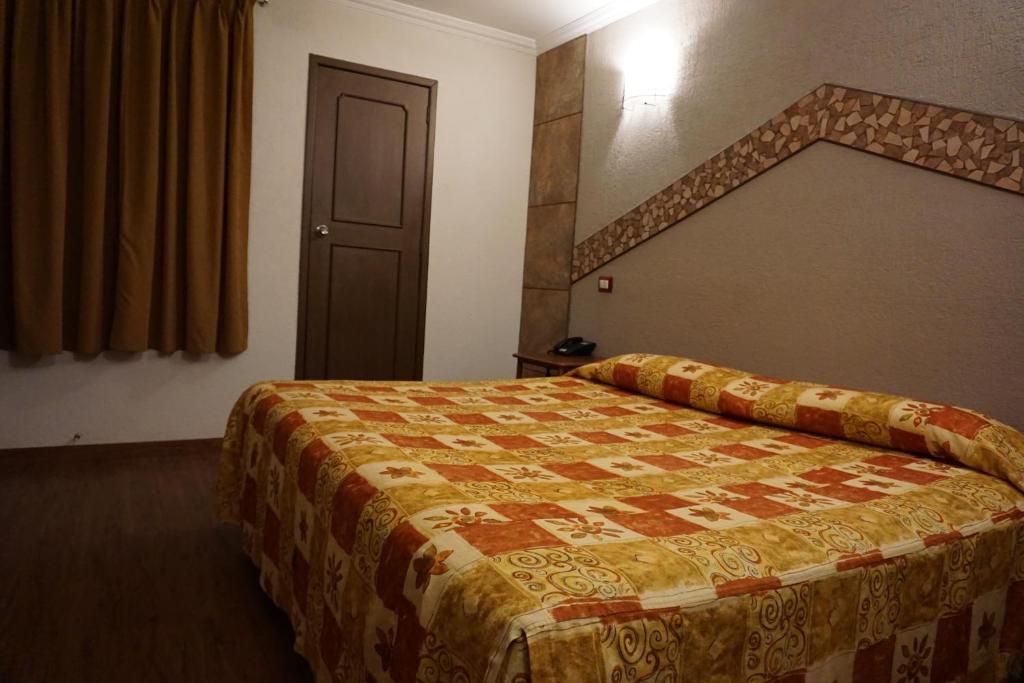 Postel nebo postele na pokoji v ubytování Hotel Plaza Crystal
