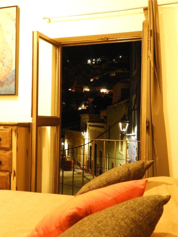 a bedroom with a window with a view of a city at Santa Posada Suites by Lunian in Guanajuato