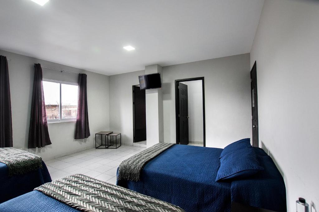 Postel nebo postele na pokoji v ubytování Hotel San Luis