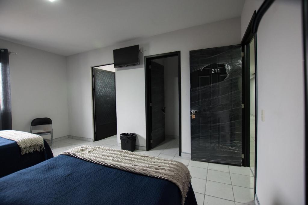 Postel nebo postele na pokoji v ubytování Hotel San Luis