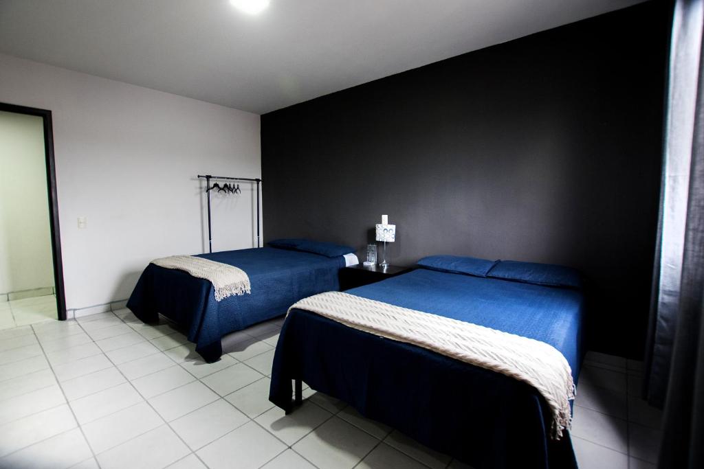 Postel nebo postele na pokoji v ubytování Hotel San Luis