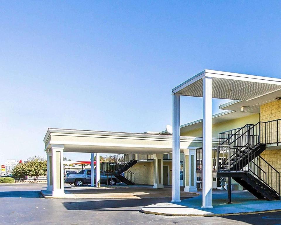 a building with a parking lot with a garage at Mill Tree Inn Millington in Millington