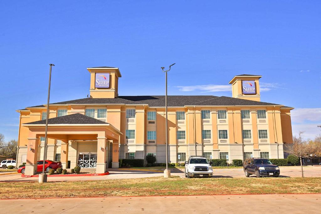 a large building with a clock tower on top of it at Sleep Inn & Suites University in Abilene