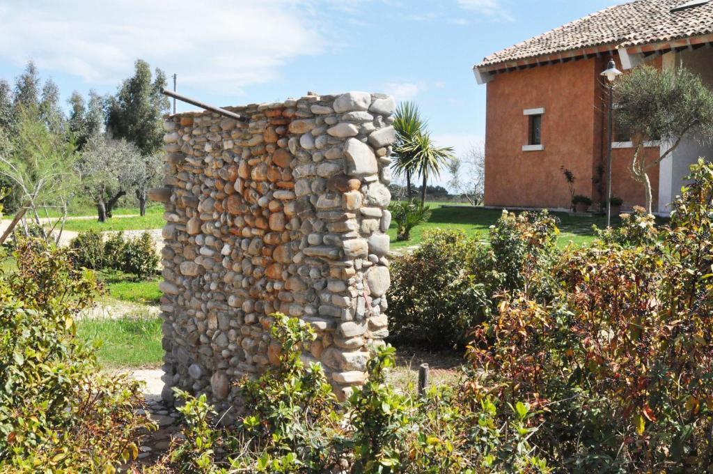 a stone wall in front of a house at Masseria Scannaturco in Marina di Pisticci