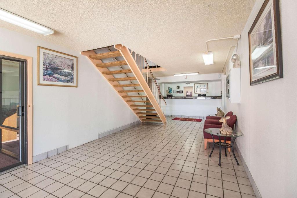 a living room with a staircase and a table at Econo Lodge in Lexington