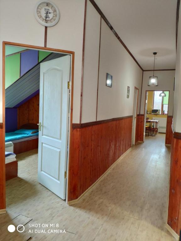 a room with a bed and a door with a mirror at Hostel Vokzal in Mukacheve