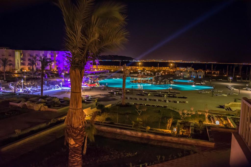 a view of a swimming pool at night at Tolip Taba Resort And Spa in Taba