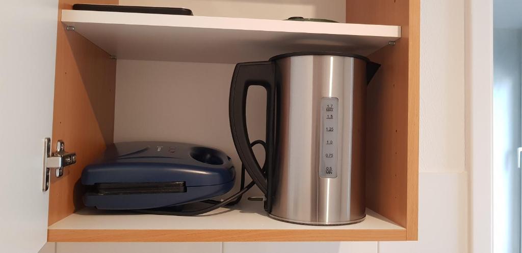 a coffee pot and a printer sitting on a shelf at B&b Broodhuis Kerkrade in Kerkrade