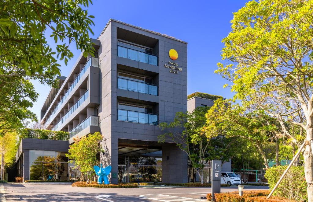 un edificio de oficinas con un letrero amarillo. en Parksunshine Jeju, en Seogwipo