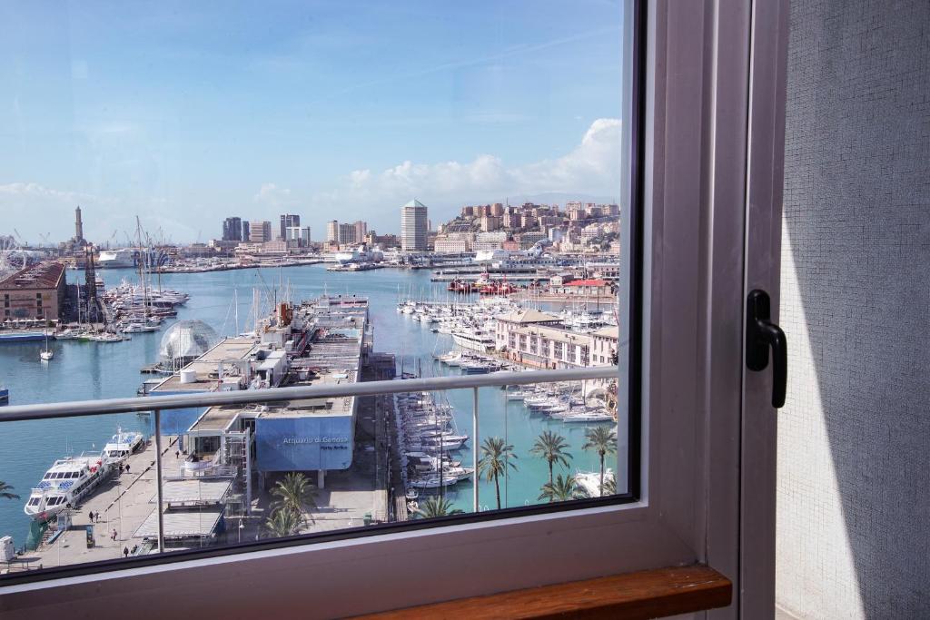 a window with a view of a harbor with boats at Bluripa Guest House in Genoa