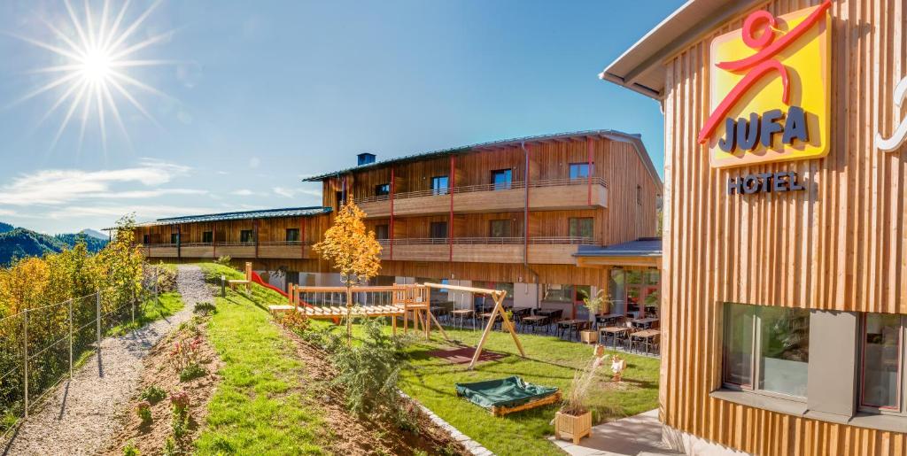 a hotel with a playground next to a building at JUFA Hotel Annaberg in Annaberg
