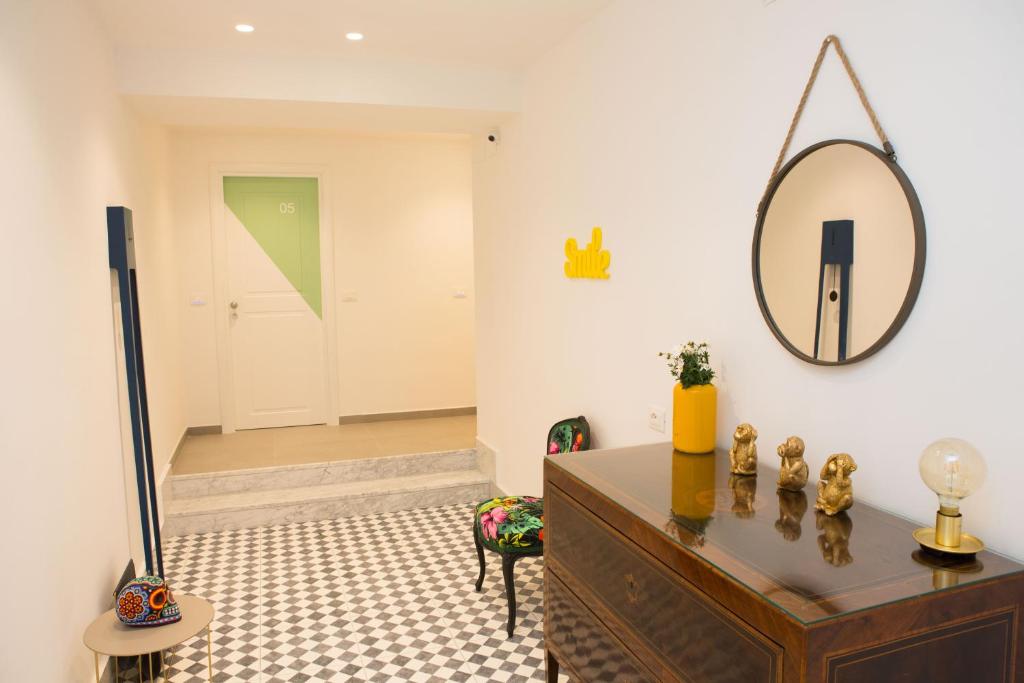 a room with a dresser and a mirror on the wall at Cocor Suites & Design in Naples