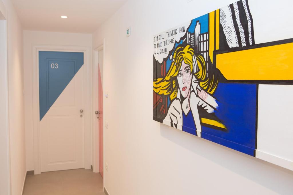 a painting hanging on a wall in a hallway at Cocor Suites & Design in Naples