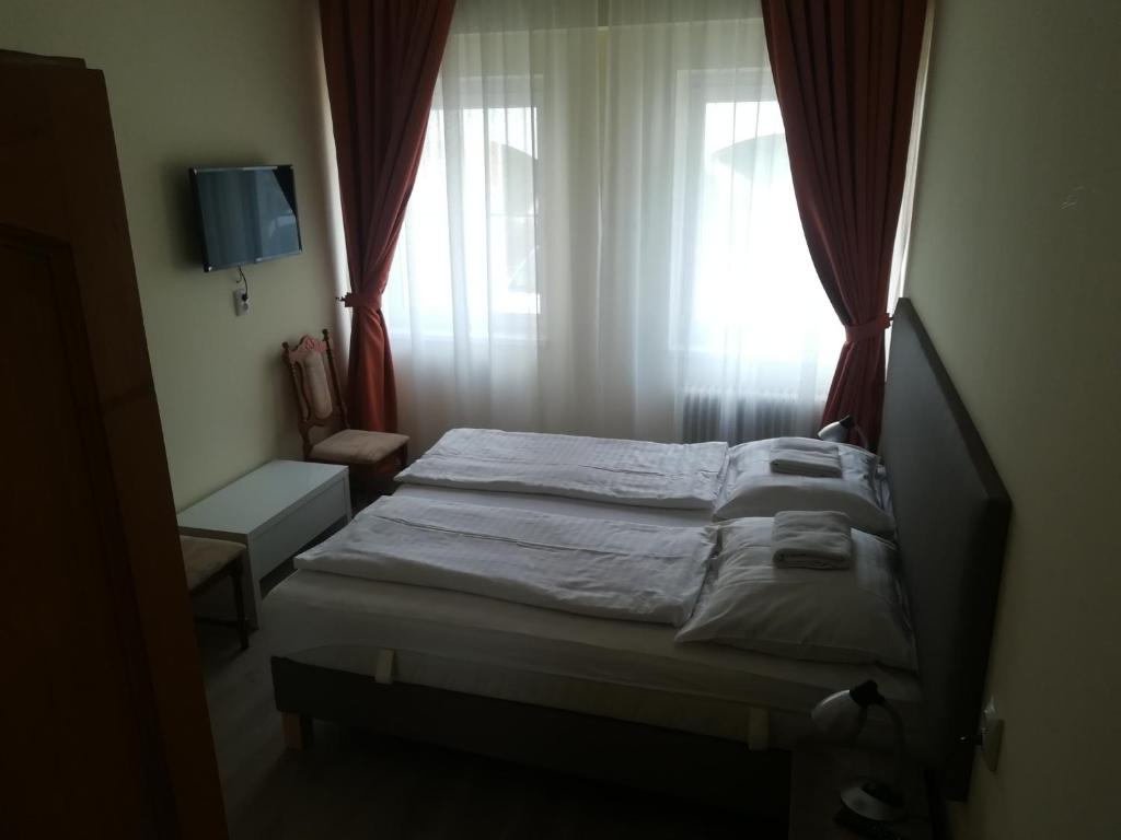 Postel nebo postele na pokoji v ubytování Áldos Panzió