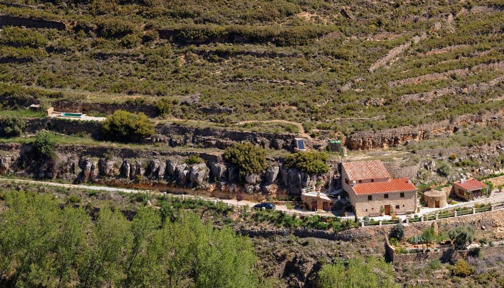 a house on the side of a mountain at La Covarxella in Culla