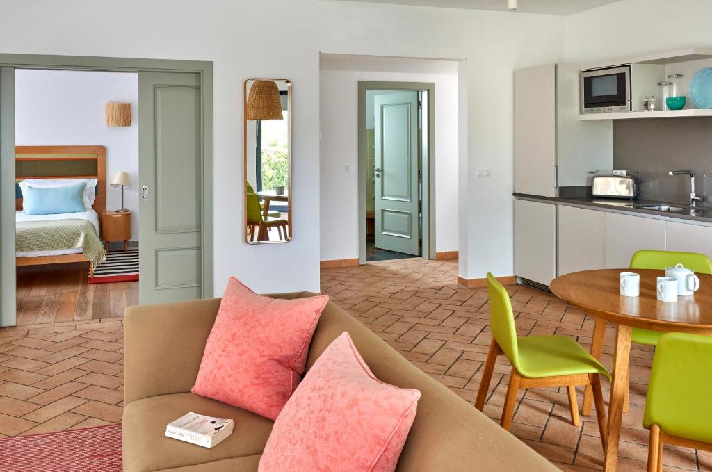 a living room with a couch and a table at Martinhal Sagres Beach Family Resort Hotel in Sagres
