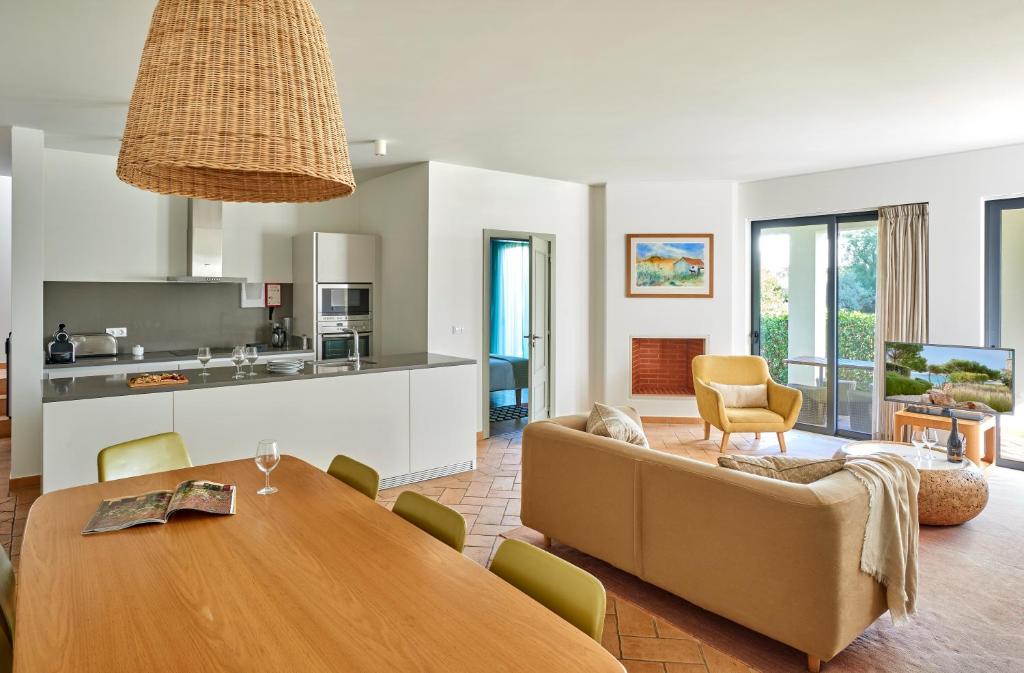 a living room with a table and a couch at Martinhal Sagres Beach Family Resort Hotel in Sagres