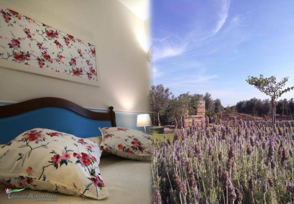 a bedroom with two pillows and a field of flowers at TENUTA ALMATELLUS in Torre Lapillo