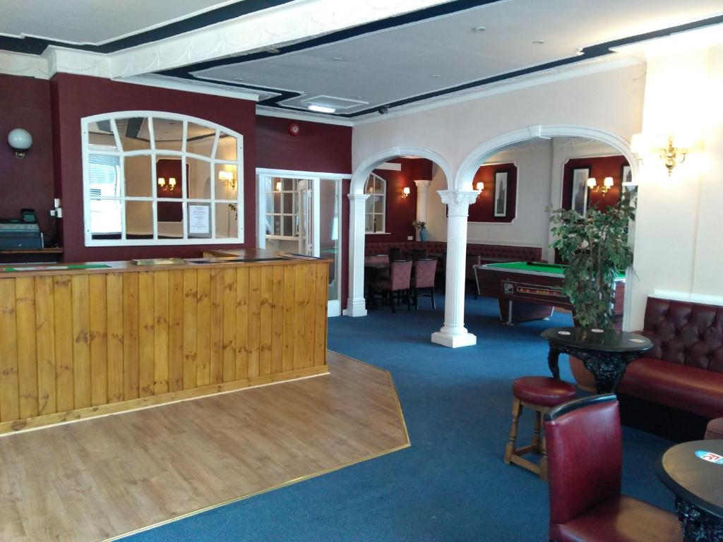 a lobby with a bar and a pool table at The Crown Hotel in Stoke on Trent