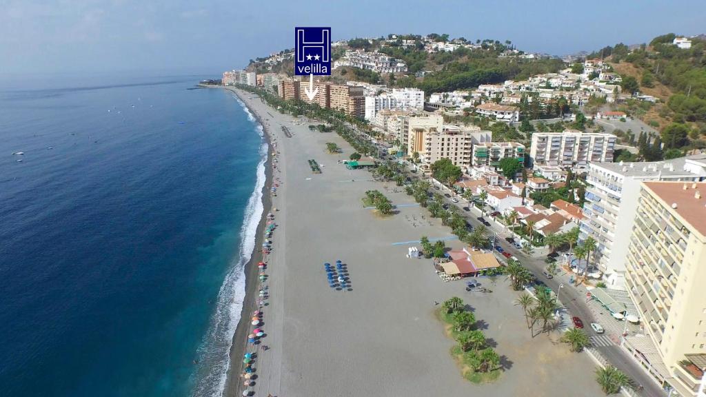 an aerial view of a beach with buildings and the ocean at Hostal Velilla in Almuñécar