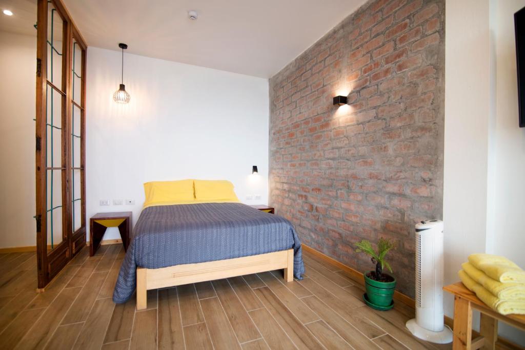Postel nebo postele na pokoji v ubytování Kauhuhu Casa Hotel