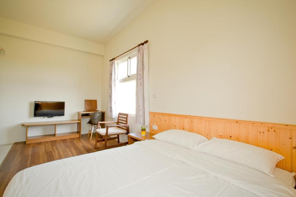 Postel nebo postele na pokoji v ubytování Penghu Sun House