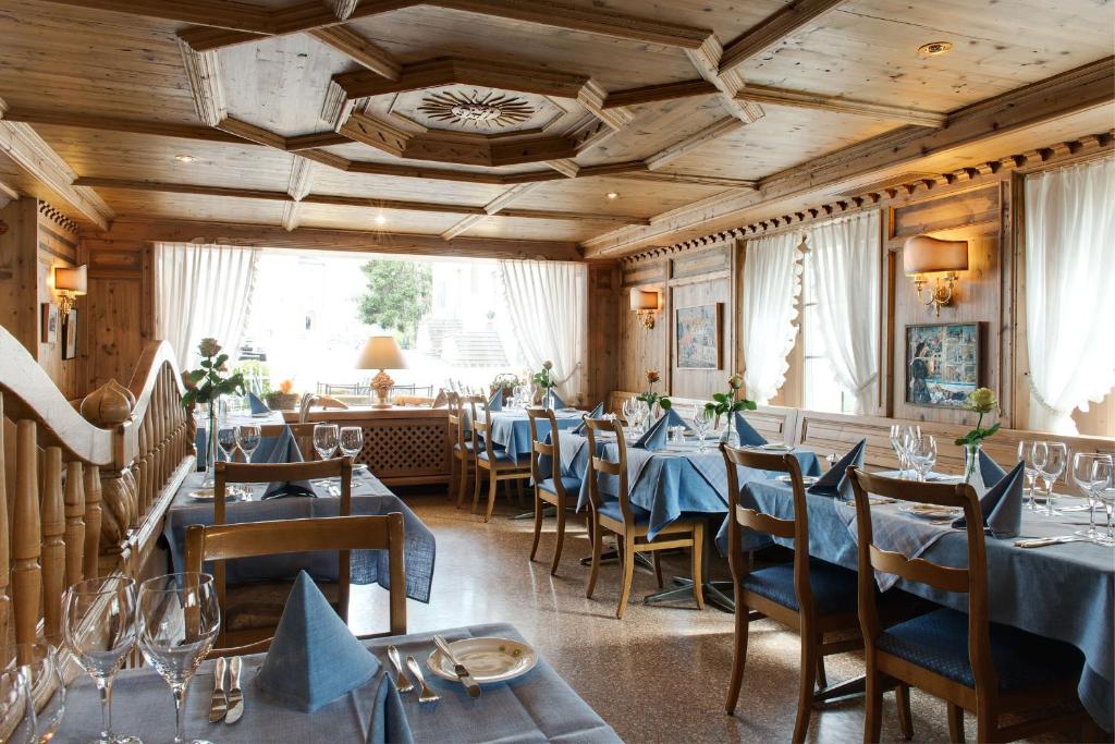 een restaurant met blauwe tafels en stoelen in een kamer bij KunstHotel Linde Garni in Einsiedeln