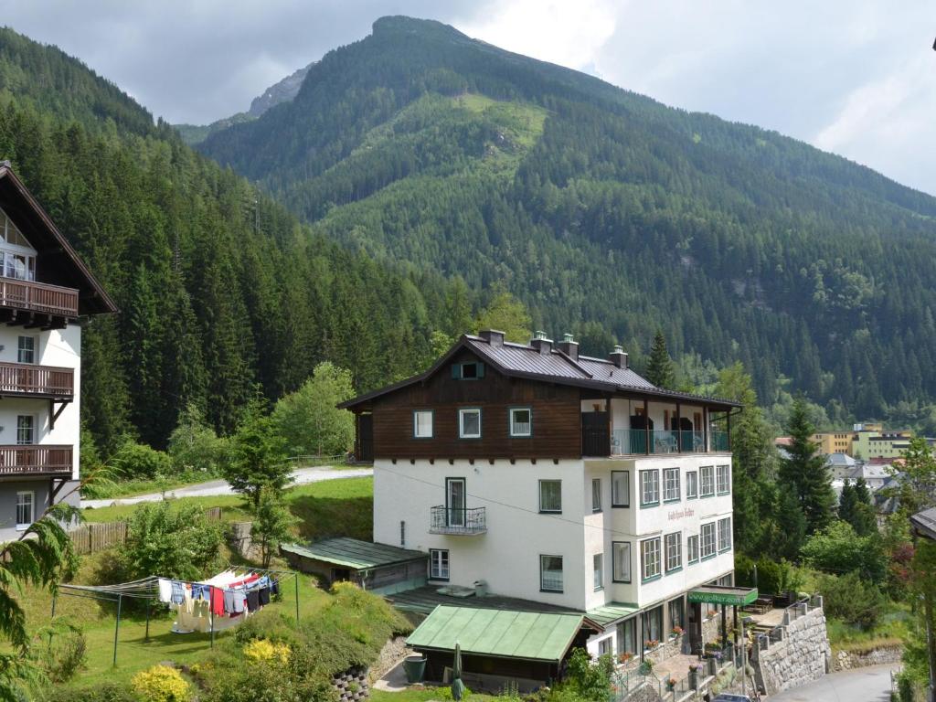 a large building in front of a mountain at Gästehaus Golker in Bad Gastein