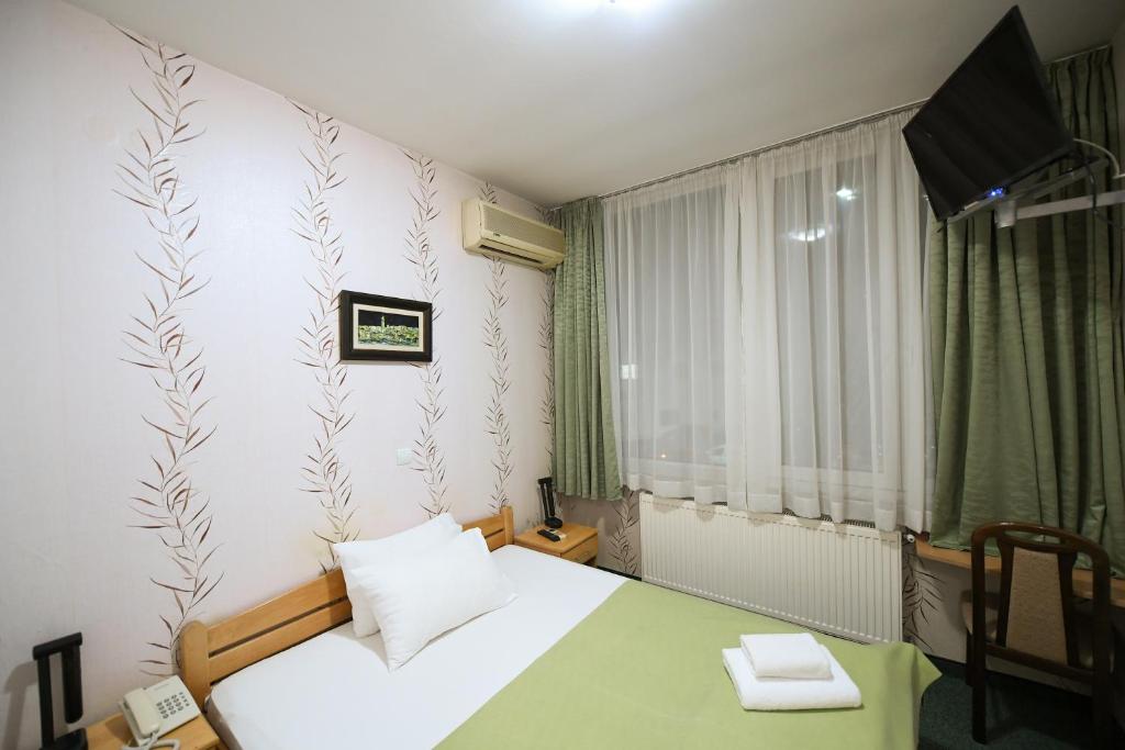 Postel nebo postele na pokoji v ubytování Hotel Slodes
