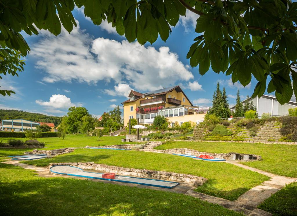 a resort with two swimming pools in a park at Landgasthof - Café Anni in Birgland