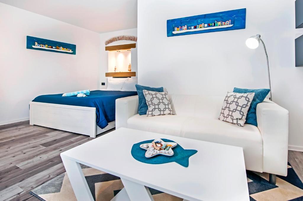 a small room with a bed and a table at Studio Biritin in Rovinj