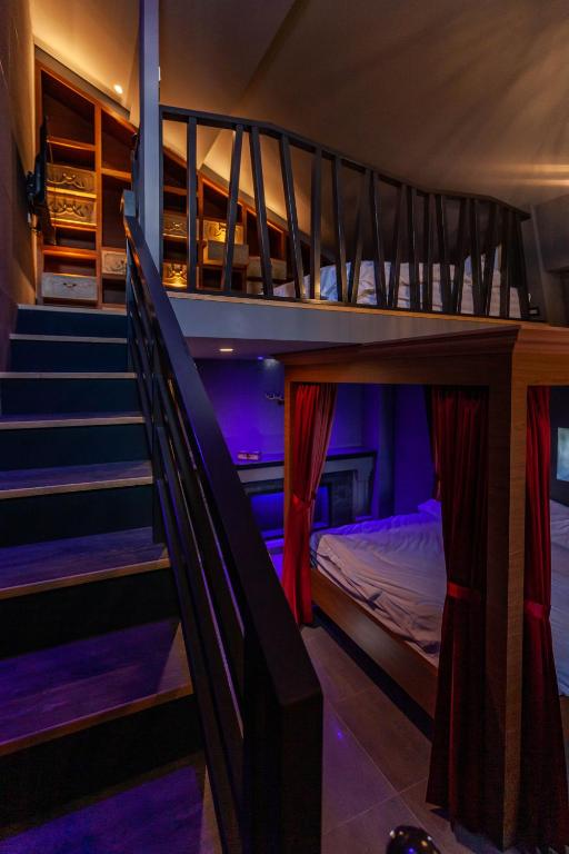 A bed or beds in a room at Hogwarts Castle Guest House