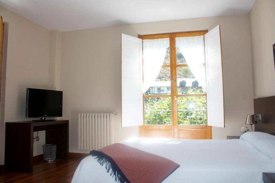 Postel nebo postele na pokoji v ubytování Hostal El Palacio