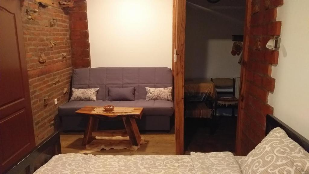 a living room with a couch and a table at Apartmani Mali Raj Rudnik in Rudnik