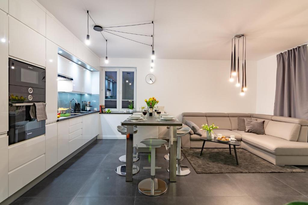 a kitchen and living room with a couch and a table at Cisza in Ustrzyki Dolne