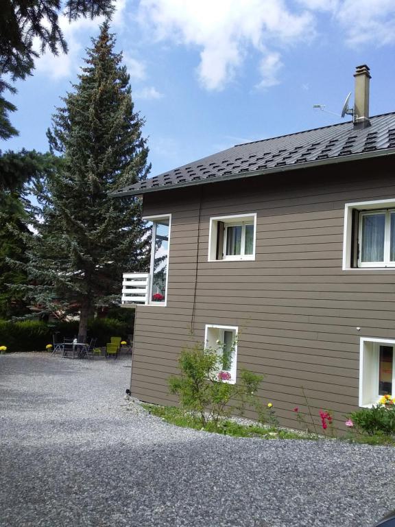 a house with a tree in front of it at Joli studio sympa in Saint-Jean-Saint-Nicolas